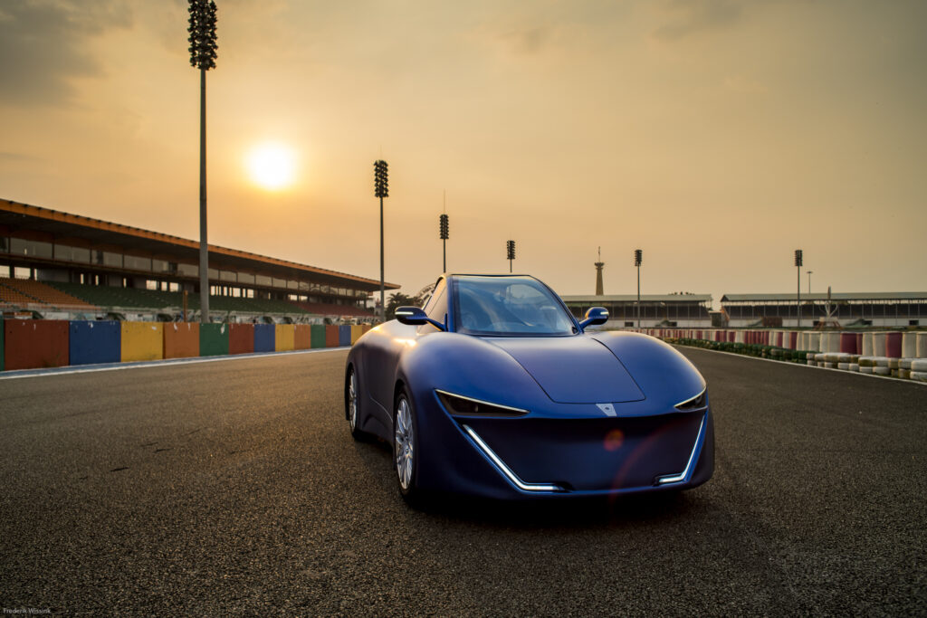 Front profile of the Quanta EV on the track at sunset.