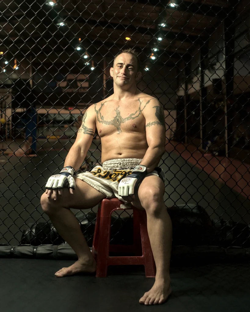 professional UFC fighter poses against a cage