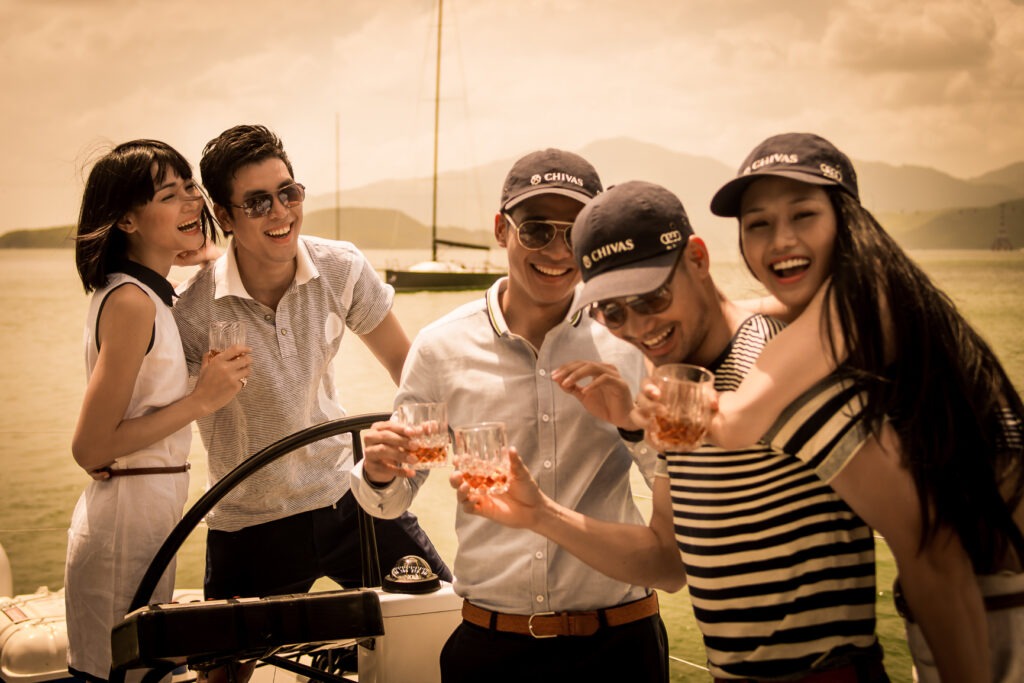 Young people enjoying drinks at sunset.